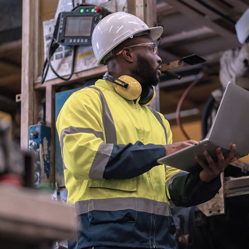 Technician inspecting industrial gas valves and pressure gauges